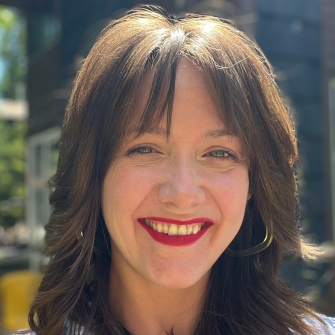 Melissa Cullens smiling at the camera on a sunny summer day